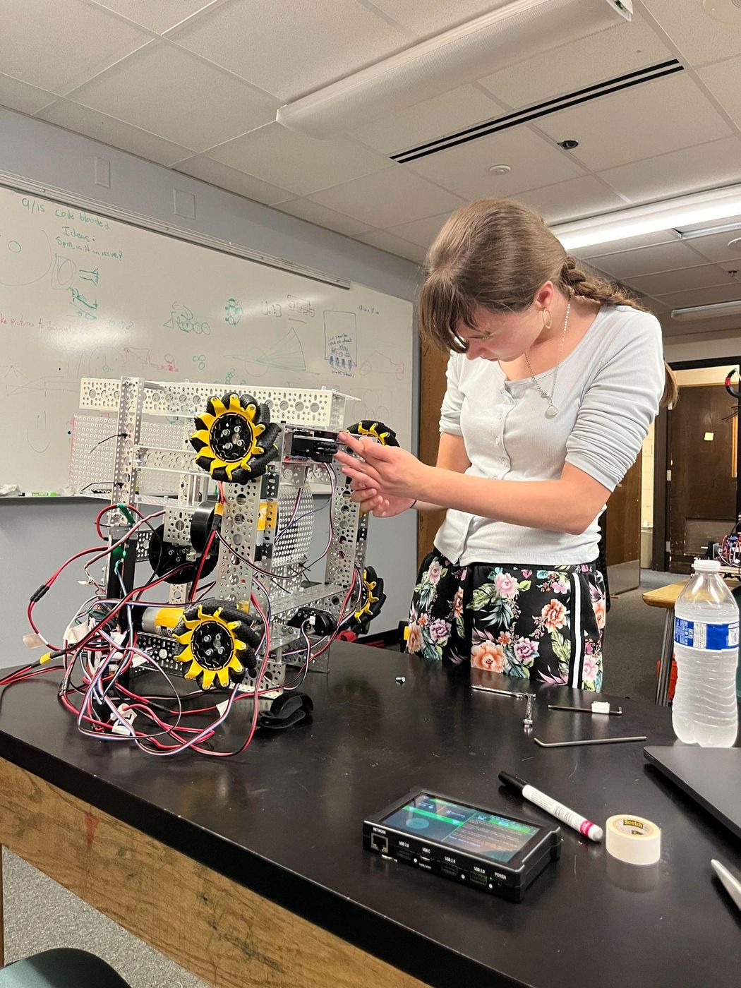 A teammate wiring the robot's control hub