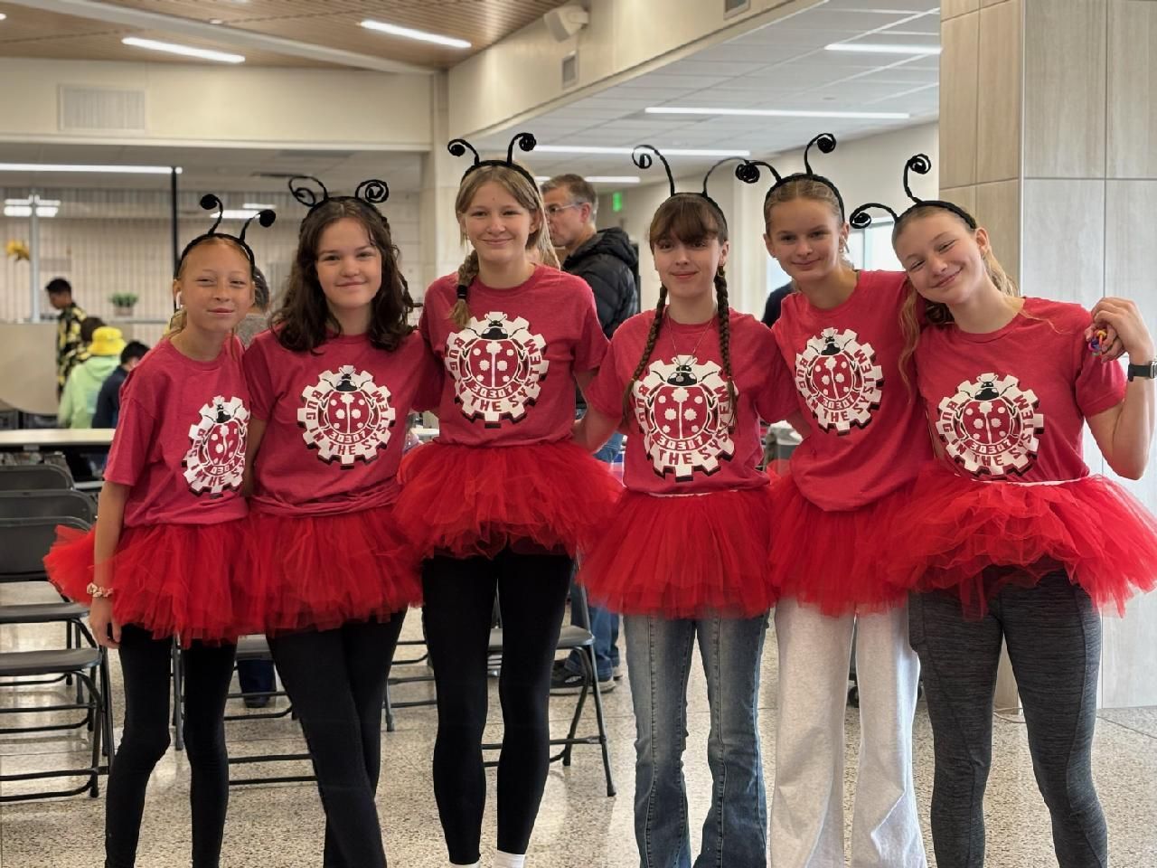 Our team in matching ladybug shirts, red tutus, and antennae